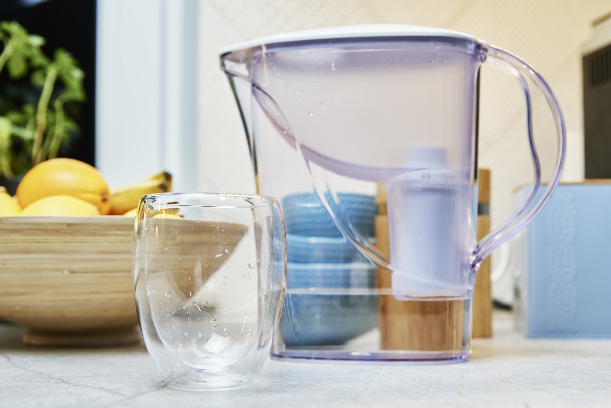 Glass and water filter on table
