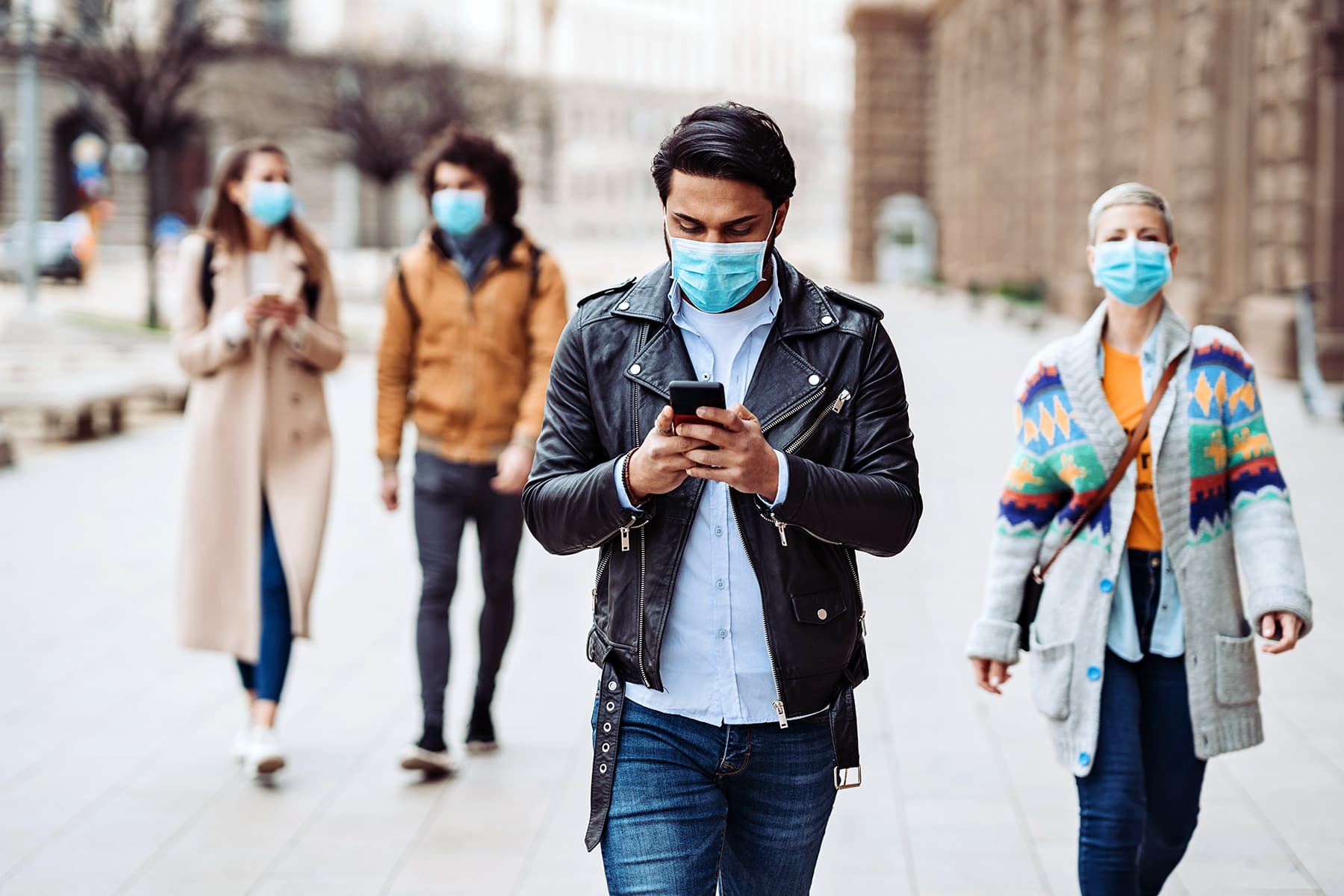 photo of group of people walking and wearing masks